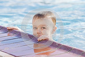 Toddler Boy Playing in a Warm Water Pool During the Winter