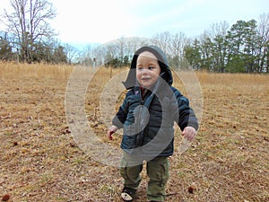Toddler Boy Plays in the Woods