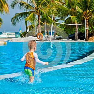 Toddler boy in resort swimming pool