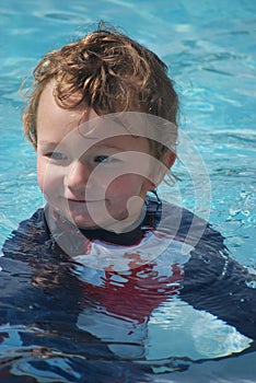 Toddler Boy Swimming in pool