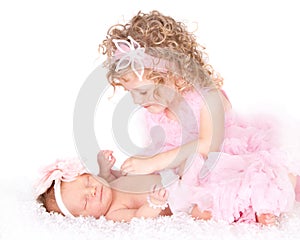 Toddler caring for her infant sister