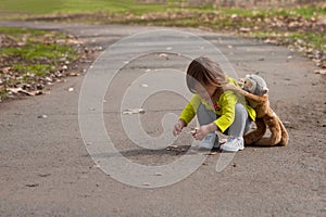 Toddler carrying stuffed animal and exploring