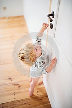 Toddler child in a dangerous situation at home.