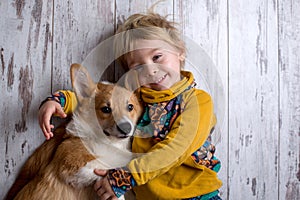 Toddler child and dog, boy and puppy playing together at home