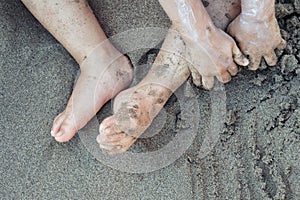 Toddler Child playing in the beach sand with sunscreen on close up abstract detail â€“ Family Beach Holiday Backgrounds Top View