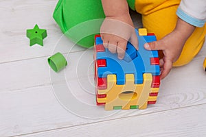 Toddler or child is playing with plastic shape sorter.