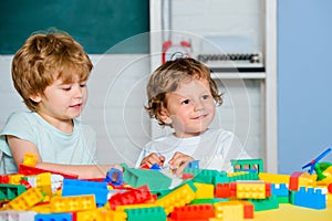 Toddler children play with blocks, trains and cars. Educational toys for preschool and kindergarten child.