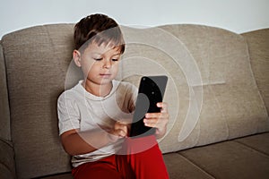 Toddler communicates via video conference using a smartphone photo