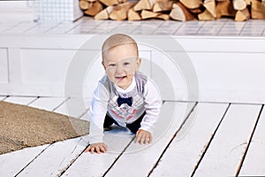 Toddler crawls across floor on all fours and smiles.