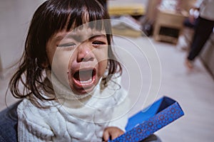 toddler crying with tear running down her cheek