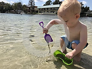 Toddler Digging in Sand