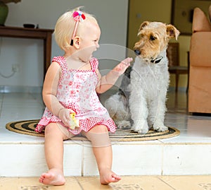 Toddler and dog. The little girl and her pet.