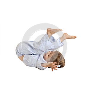 Toddler doing somersault, isolated on white