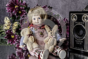 Toddler doll and antique Brownie Target camera