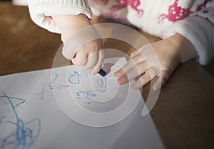 Toddler drawing with crayons