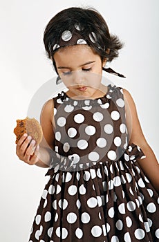 Toddler eating chocolate chip cookie