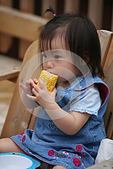 Toddler eating corn on the cob