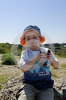 Toddler eating a sandwich at nature reserve