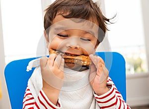 Toddler eating a toast