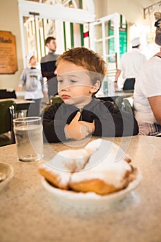 Toddler Enjoying Beignets at Cafe Du Monde