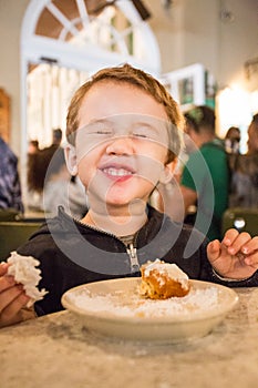 Toddler Enjoying Beignets at Cafe Du Monde photo