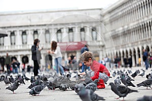 Toddler feeding the pigeons