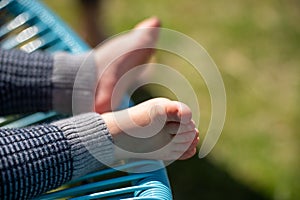 toddler feet in a chair. baby foot close up