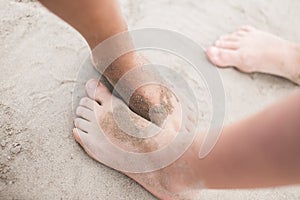 Toddler feet on sand at the beach