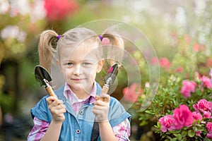 Toddler with flower basket. girl holding pink flowers
