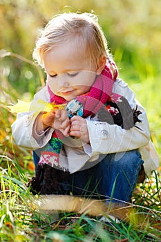 Toddler girl in autumn park