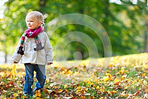 Toddler girl in autumn park