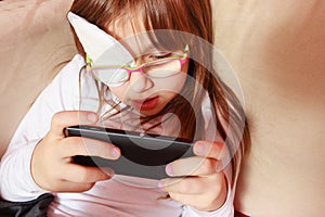 Toddler girl with bandage on eye playing games