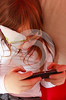 Toddler girl with bandage on eye playing games