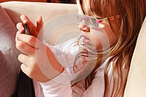 Toddler girl with bandage on eye playing games