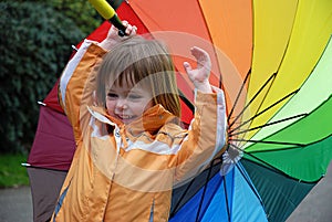 Toddler girl with colorful umbrella