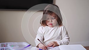 Toddler girl is coloring book alone. Stop gesture, child online privacy. Social media problem of parents. Preschool