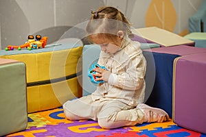 Toddler Girl Concentrating on Puzzle Toy