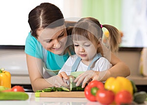 Toddler girl cooking with her mother