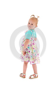 Toddler girl dancing in summer dress