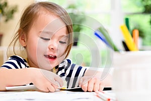 Toddler girl drawing and doing crafts