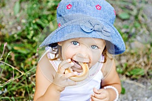 Toddler girl eating cracknel photo
