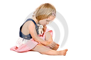 Toddler girl examines her toes