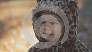 Toddler girl exploring a park on a cold fall day.