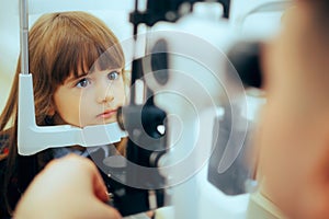 Toddler Girl During Eye Examination with a Slit Lamp Microscope.