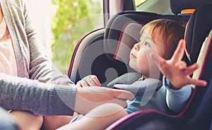 Toddler girl in her car seat