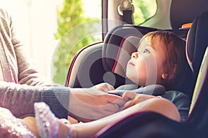 Toddler girl in her car seat