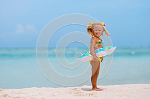 Toddler girl with Inflatable circle on beach