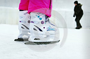 Toddler girl learning how to ice skate