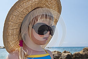 Toddler girl looks in Audrey Hepburn - style glasses photo