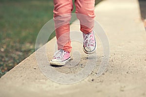 Toddler girl model posing on street